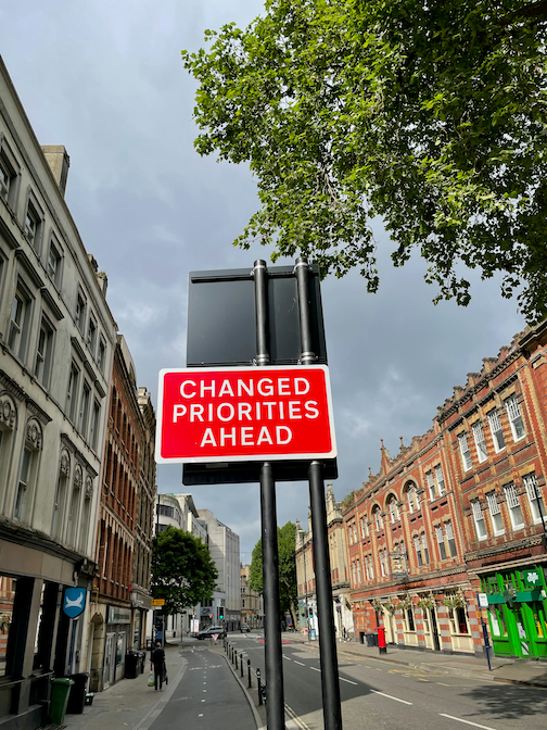 Changed Priorities Road Sign