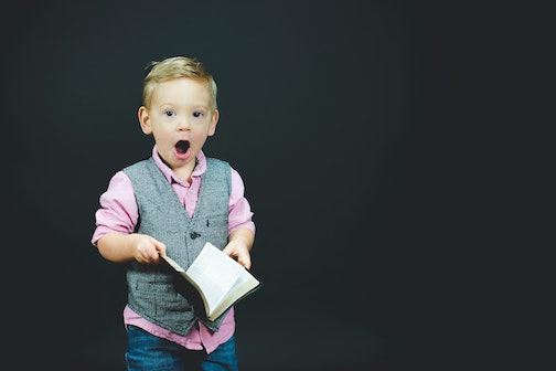 Surprised boy with book