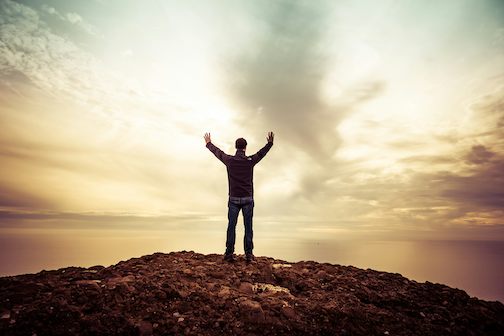 Man worhipping on hilltop