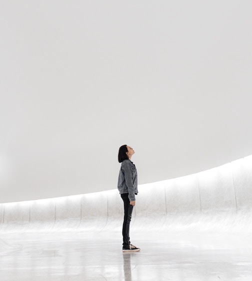 Woman looking at blank wall